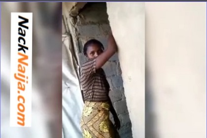 A crippled woman blows hot in an uncompleted building